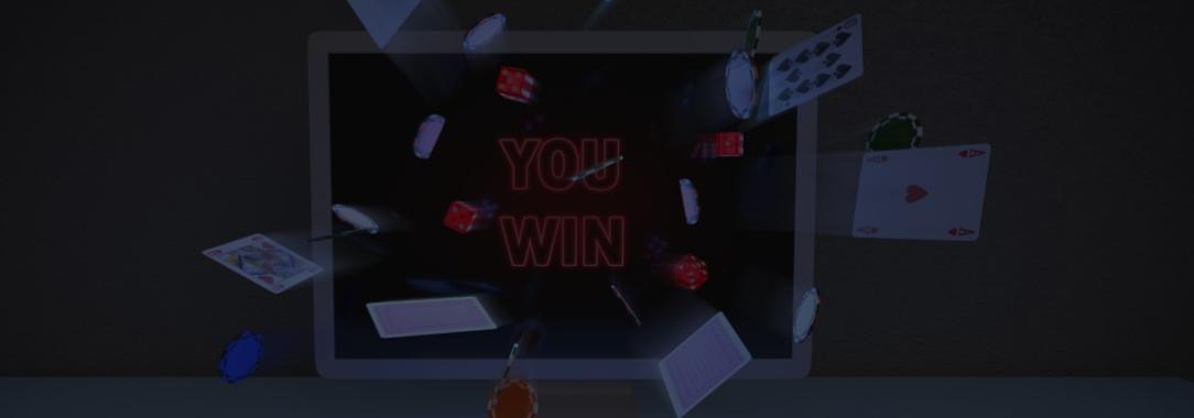 An illustration of a PC on a blue table with the words ‘you win’ onscreen and cards coming out of the screen on grey background