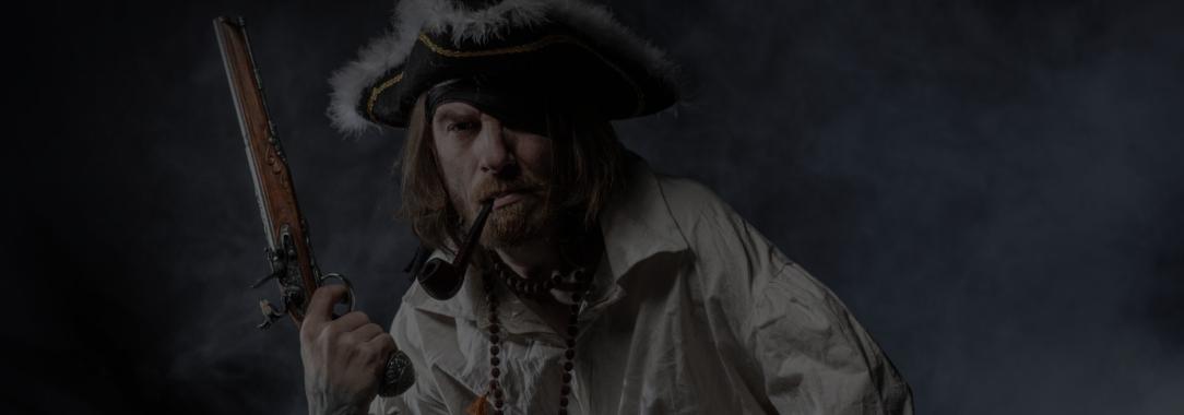 A photo of a bearded pirate with a hook for hand and a pipe in his mouth holding a flintlock pistol on a smoky dark background