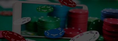 a mobile phone sitting on a poker table with chips coming out of the phone and cards on the table