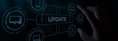 A hand pointing at a digital computer software update concept image in shades of blue