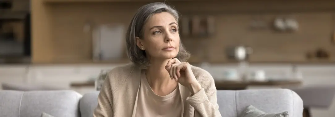 a middle-aged woman in deep contemplation as she tries to arrive at a good decision