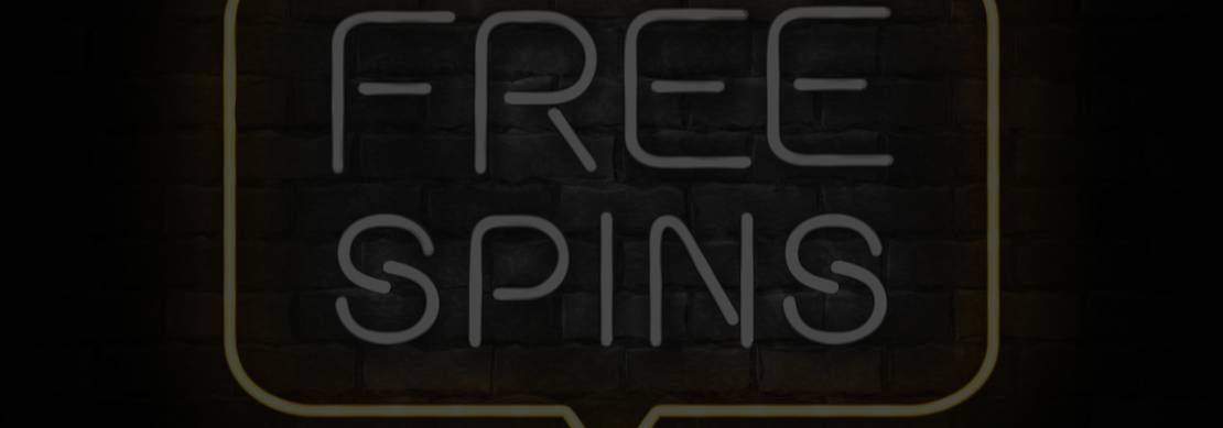 A realistic neon sign on a blackened brick wall featuring Free Spins as text