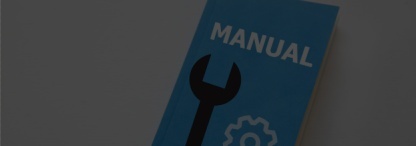 A blue instruction manual book on an off-white surface 