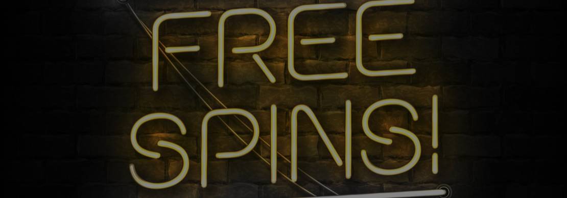 An illustration of a yellow neon sign featuring the words ‘Free Spins!’ on a dark background with bricks